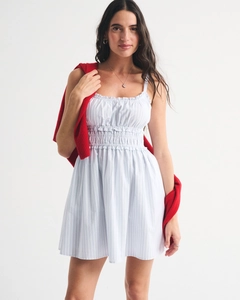 Detail of smocked waist and ruffled neckline on a blue striped floral summer dress