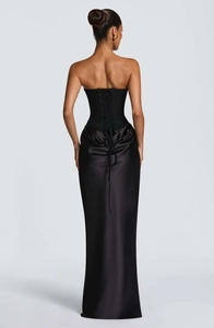 Detailed back view of a black satin evening gown featuring an elegant corset lace-up design