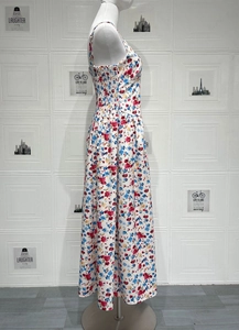 Detail of floral spaghetti strap maxi dress featuring smocked elastic waist and A-line silhouette