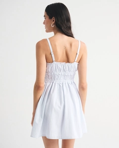 Detail of smocked elastic back and adjustable straps on blue striped summer dress