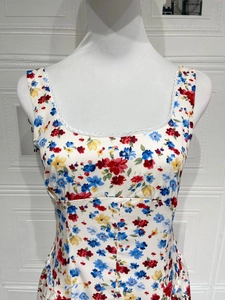 Close-up of floral print dress featuring square neckline and delicate white lace trim