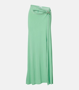 Détail d'une jupe vert menthe avec découpe à la taille, fronces et œillets métalliques