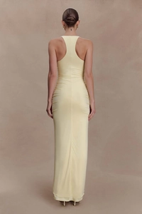 Close-up of side ruching details on a cream yellow bodycon maxi dress for women