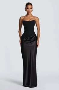 Detail of elegant black corset evening gown with luxurious satin draped long skirt