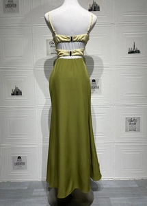 Detail view of the sexy backless dress with a pale yellow top and olive green maxi skirt