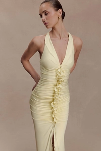 Detail view of the elegant lemon yellow halter neck dress with ruffled front and ruching