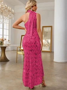 Macro detail of the sparkling rose pink sequins and asymmetric neckline on the long dress