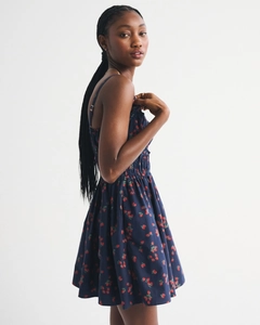 Detail of navy blue strawberry print sundress with smocked waist and spaghetti straps