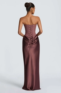 Close-up detail of the corset-style lace-up back on a purple satin evening dress