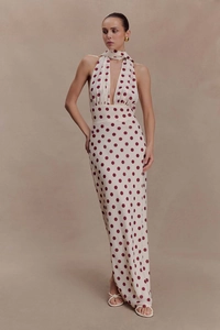 Close-up of deep V-neckline halter dress with polka dots and matching neck scarf