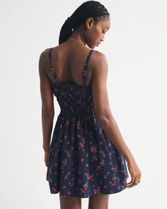 Detail of adjustable straps and elastic shirring on navy strawberry floral mini dress