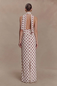 Detail of elegant backless halter neck maxi dress with polka dots and chic tie ribbons