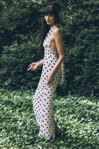Detail view of white and red polka dot halter neck backless maxi dress in forest
