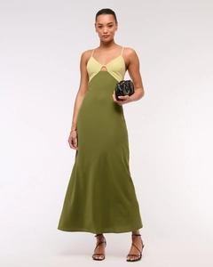 Detail of elegant two-tone slip dress showing yellow top and olive green satin skirt
