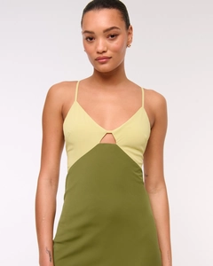 Detailed view of backless V-neck dress with green color-blocking and hollow-out design