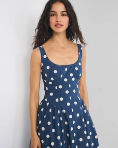 Detail of square neckline with delicate white lace trim on navy blue polka dot dress