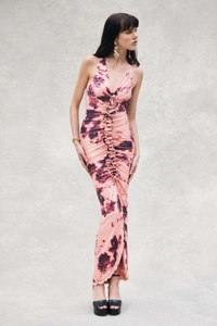 Detail of metal ring connector and ruched pleats on pink tie-dye halter neck maxi dress