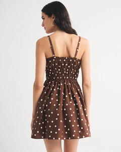 Detail of the elastic shirred back and thin straps on a brown polka dot sundress