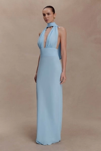 Detail of light blue halter neck evening dress with deep V-neck and flowing tie neck sash