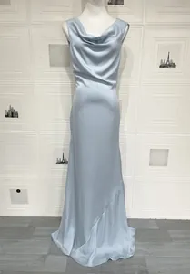 Detail of light blue satin gown featuring a cowl neck design and silky smooth texture