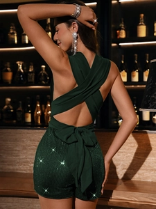 Deep green sequin jumpsuit featuring a bold backless design with crisscross straps