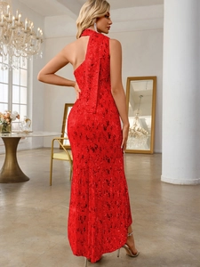 Detail of red sequin evening dress with elegant single shoulder and long flowing ribbon