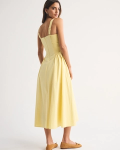 Detail view of the yellow midi dress with a smocked back and elegant wide straps