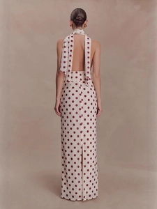 Chic white halter maxi dress with red polka dots and elegant back tie details
