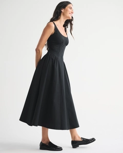 Side view detail of a slim-fit black sleeveless A-line dress with delicate lace trim edging