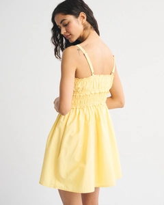 Detail view of the smocked back and delicate spaghetti straps on this floral summer dress