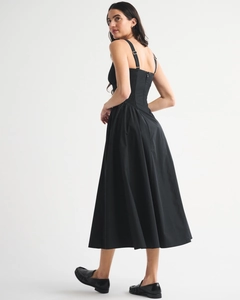Detail of slim fit A-line midi dress featuring back zipper and elastic pleated texture