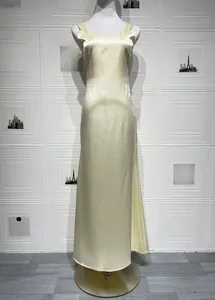 Close-up of champagne satin dress featuring V-neck strap design and silky texture