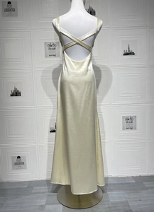 Detail of cross-back straps and open back on a champagne satin evening dress