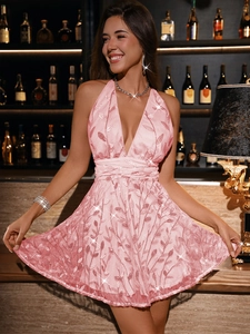 Close-up of pink sequin leaf embroidery and crisscross waist on a backless dress