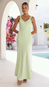 Detail of light green satin slip dress with elegant V-neck and a flowy maxi silhouette