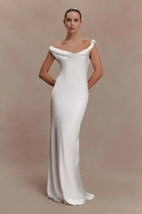 Close-up of elegant white satin evening gown featuring a cowl neck and smooth silk texture