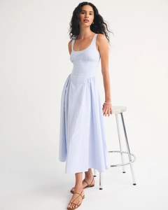 Detailed view of light blue striped midi dress with sleeveless design and cinched waist