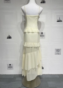Detail of multi-layered ruffle hem and lightweight chiffon fabric on yellow summer dress