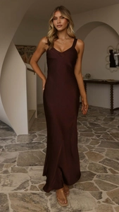 Macro shot of deep chocolate satin fabric texture and sleek plunging V-neckline detail