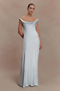 Close-up of elegant cowl neck design with white lace trim on light blue satin dress