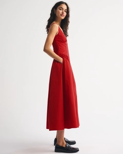Detail view of a red A-line camisole dress featuring functional side seam pockets