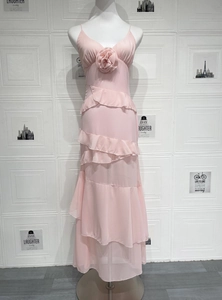 Detailed view of pink chiffon ruffles and handmade 3D roses on a slim fit maxi dress