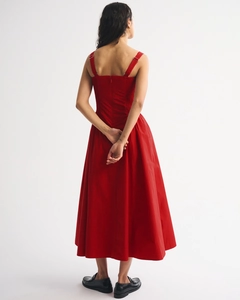 Detail view of red A-line midi dress featuring adjustable straps and hidden back zipper