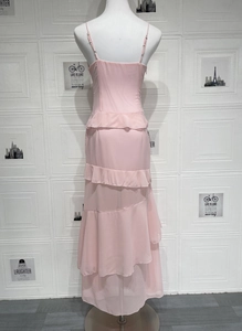 Detail of the light pink tiered ruffle layers and lightweight fabric on backless dress