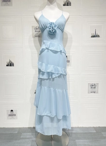 Detail of sky blue dress with 3D floral applique and layered ruffle chiffon hemline