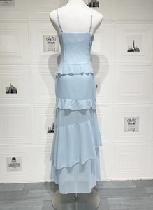 Detailed view of tiered ruffles on light blue backless maxi dress in chiffon