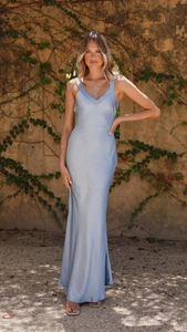 Detail of light blue satin maxi dress featuring elegant v-neck and smooth fabric texture