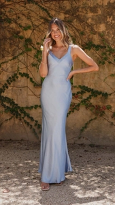 Detail of light blue satin slip dress showing elegant V-neck and smooth silk texture