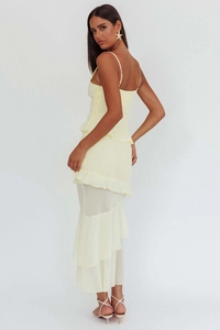 Detail of multi-layered ruffle hem on a cream backless halter maxi dress with sheer tulle