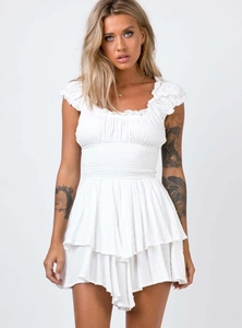 Close-up of white Swiss Dot fabric texture and smocked elastic waist detail on summer dress